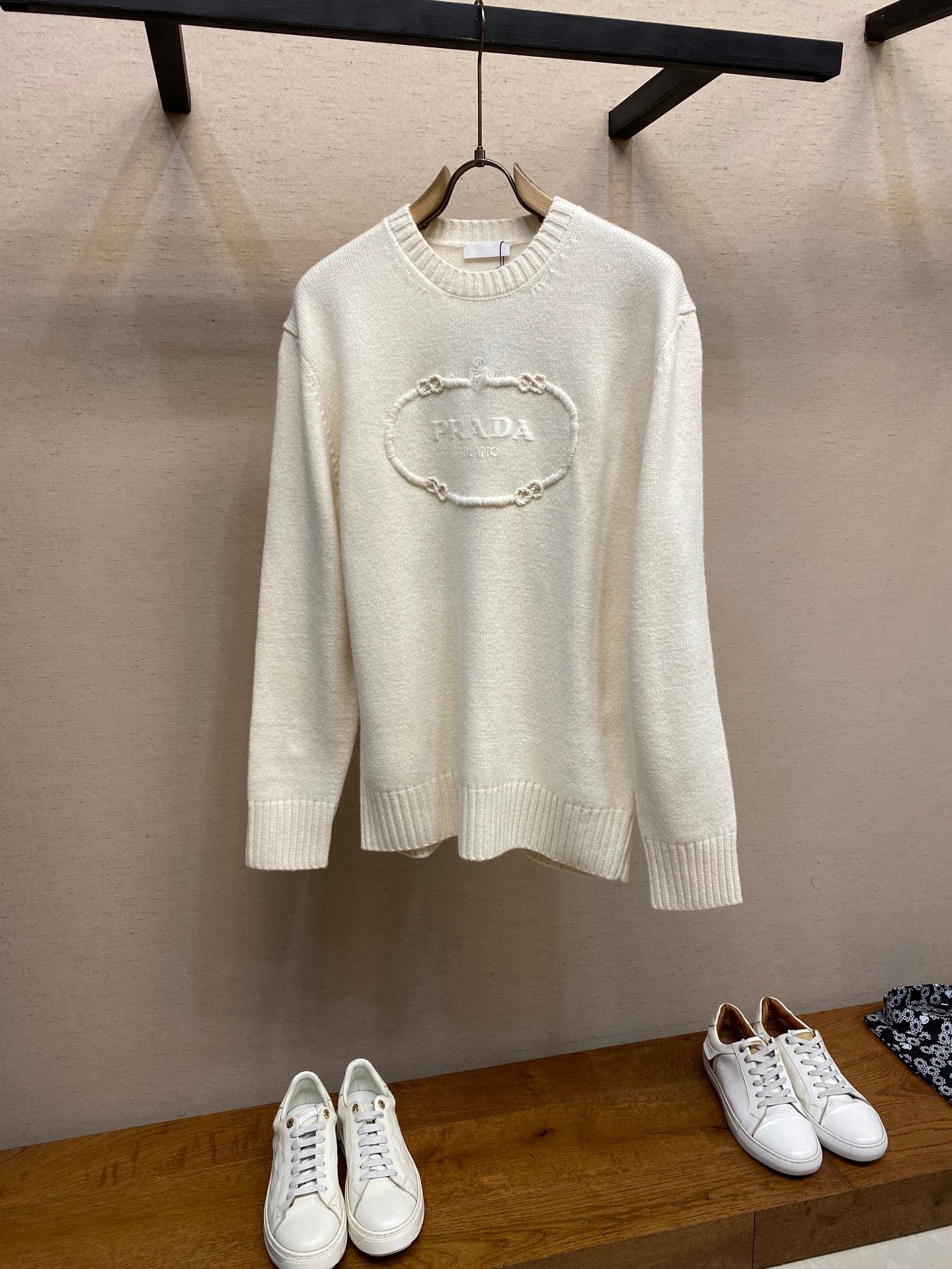Cream long-sleeve knit sweater with PRADA chain logo on front, crew neckline