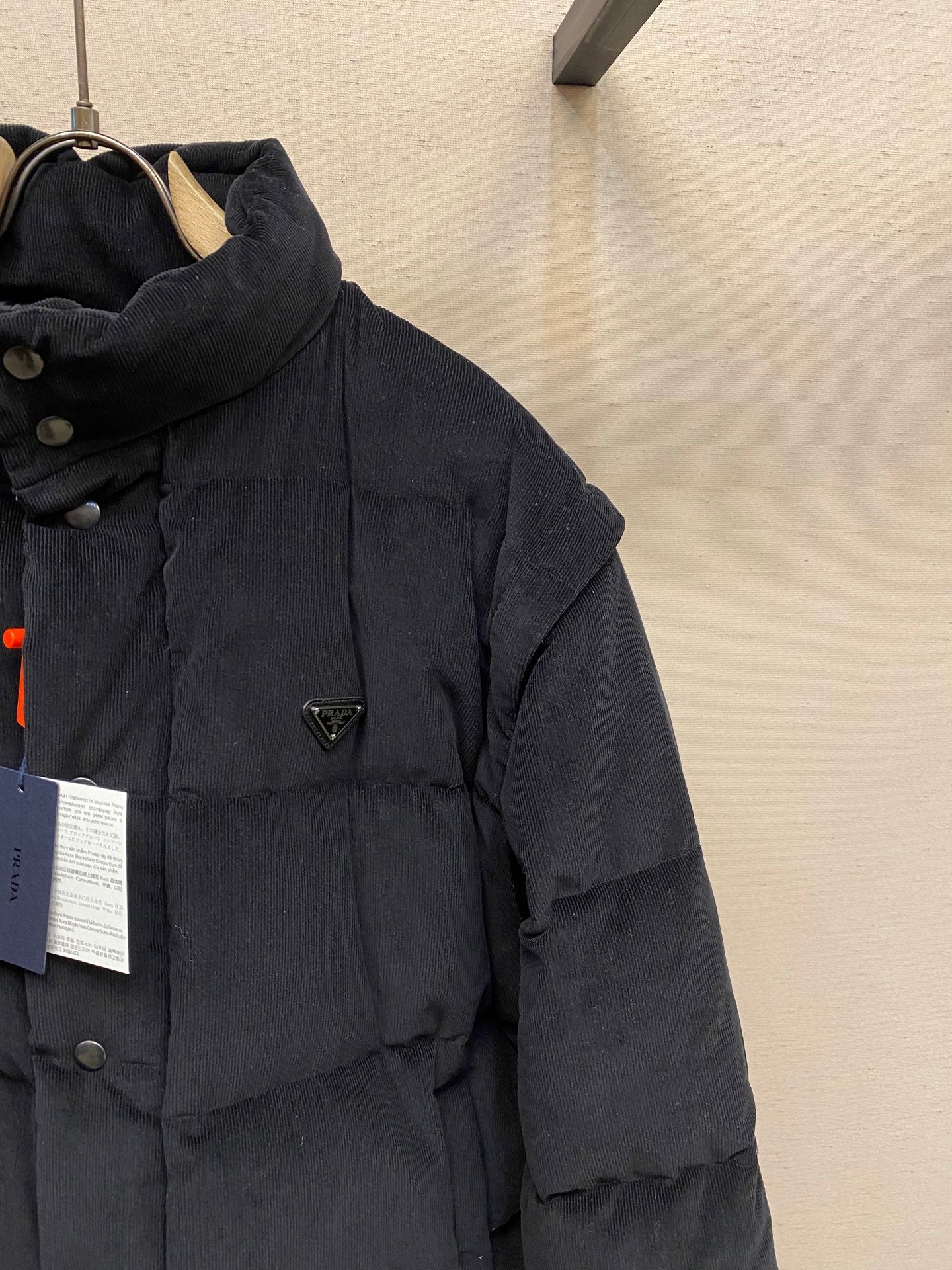 Black Prada puffer jacket with hood and triangle logo plaque