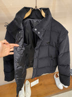 Black hooded puffer jacket with snap front, side zipper and inner tags