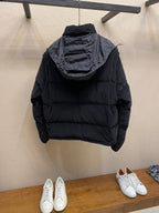 Black hooded puffer jacket, rear view with large hood and quilted shoulders