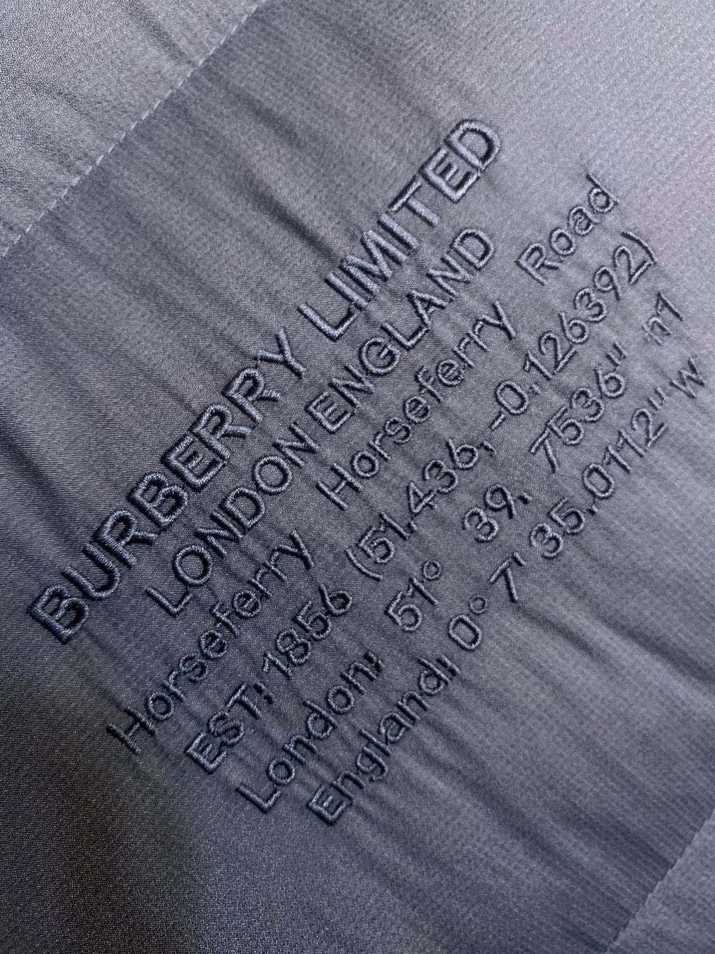 Dark gray fabric label text with LIMITED logo and care details