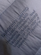 Dark gray fabric label text with LIMITED logo and care details