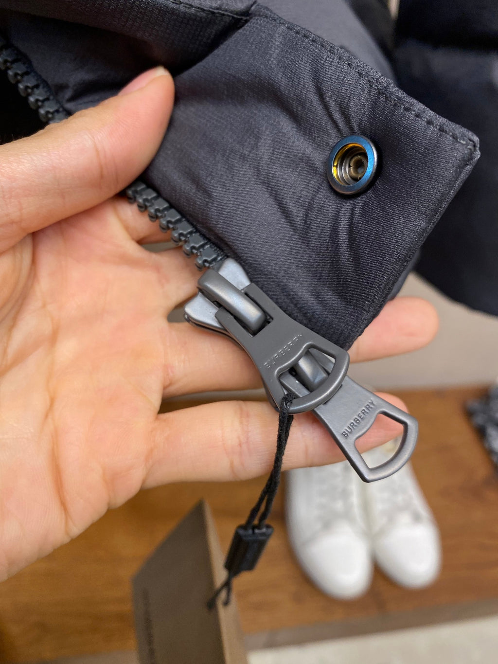 Dark gray puffer jacket zipper pull with ring clip and toggle