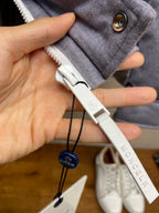 Moncler puffer jacket zipper pull and hood toggle detail, light gray