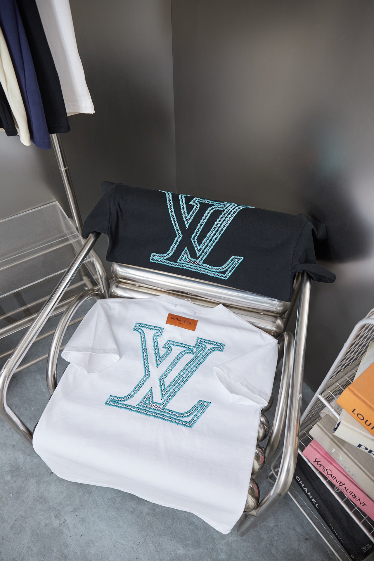 Set of two Louis Vuitton logo T-shirts on display: navy and white with turquoise print
