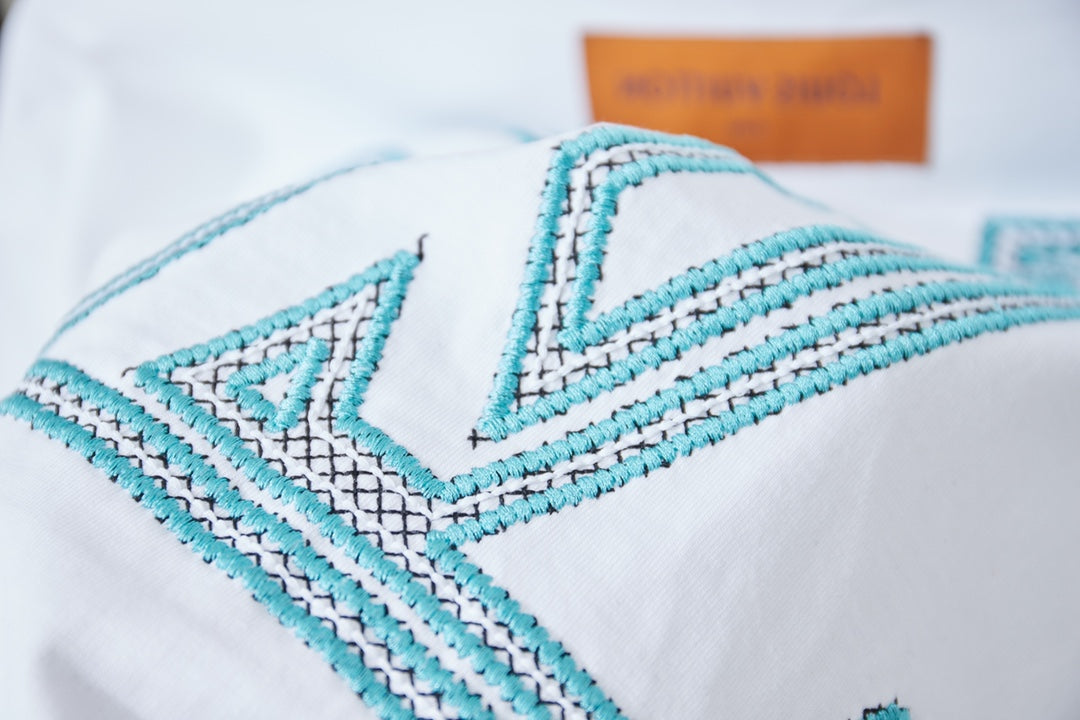 Louis Vuitton logo T-shirt close-up of turquoise stitching detail and orange tag