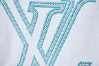 Louis Vuitton logo T-shirt close-up of turquoise LV logo on white fabric