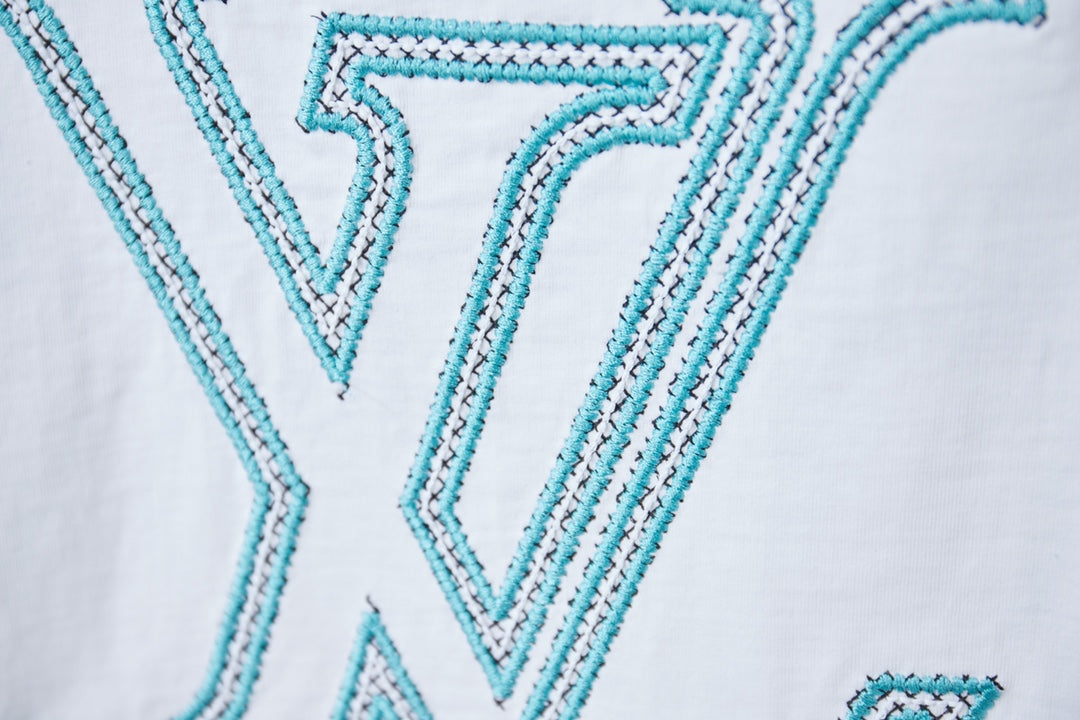 Louis Vuitton logo T-shirt close-up of turquoise LV logo on white fabric