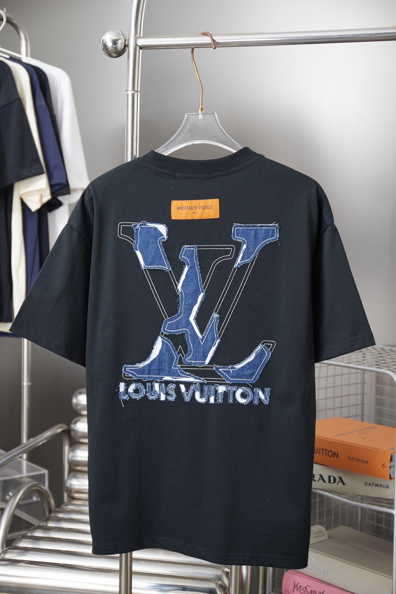 Louis Vuitton short-sleeve T-shirt back view in dark fabric with large blue LV print