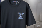 Close-up of dark short-sleeve T-shirt with small blue embroidered LV monogram on chest