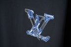 Close-up of blue stitched LV monogram patch on dark short-sleeve T-shirt