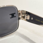 Close-up of dark lens sunglasses with metal hinge and brand logo on temple
