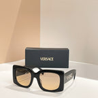 Black square sunglasses with gradient beige lenses and VERSACE logo on temple