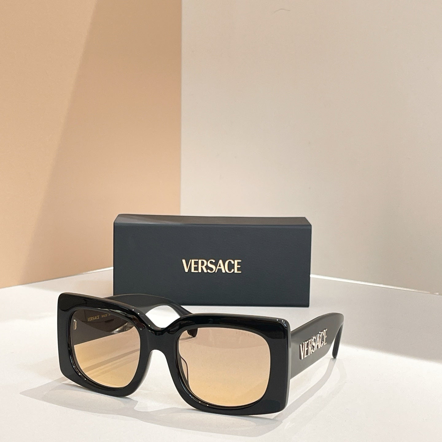 Black square sunglasses with gradient beige lenses and VERSACE logo on temple