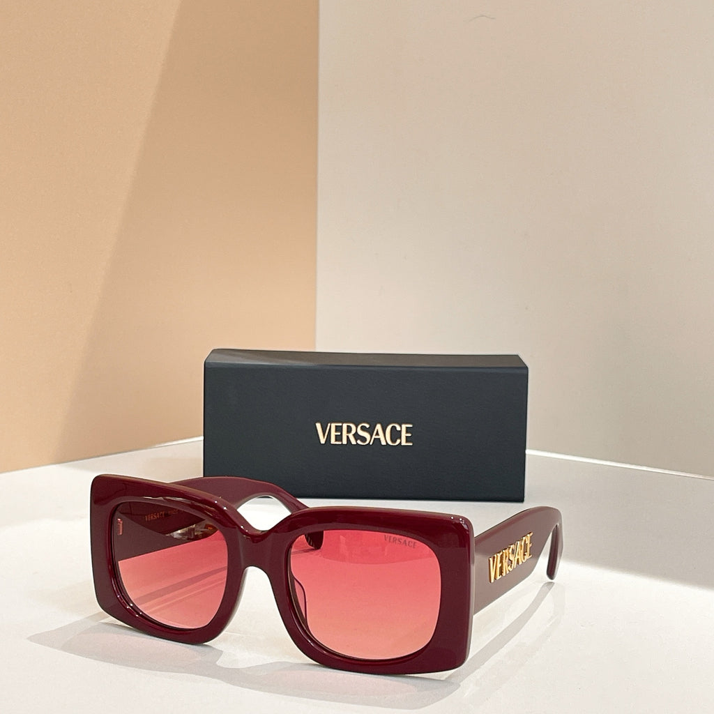 Burgundy red square sunglasses with red-tinted lenses and VERSACE logo on temple