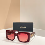 Burgundy red square sunglasses with red-tinted lenses and VERSACE logo on temple
