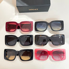 Assorted sunglasses with red, black, and grey frames and colored lenses