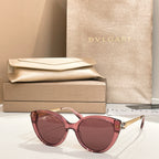 Pink round sunglasses with gold-tone temple detail and pink-tinted lenses