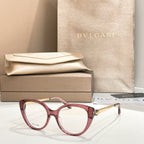 Burgundy round eyeglasses with gold-tone temple detail and clear lenses