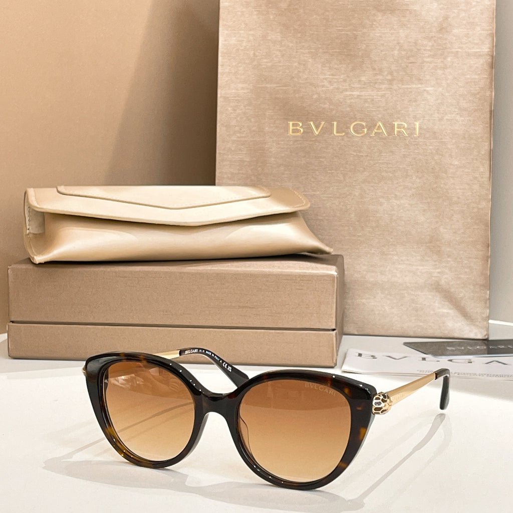 Black round sunglasses with gold-tone temple detail and brown-tinted lenses