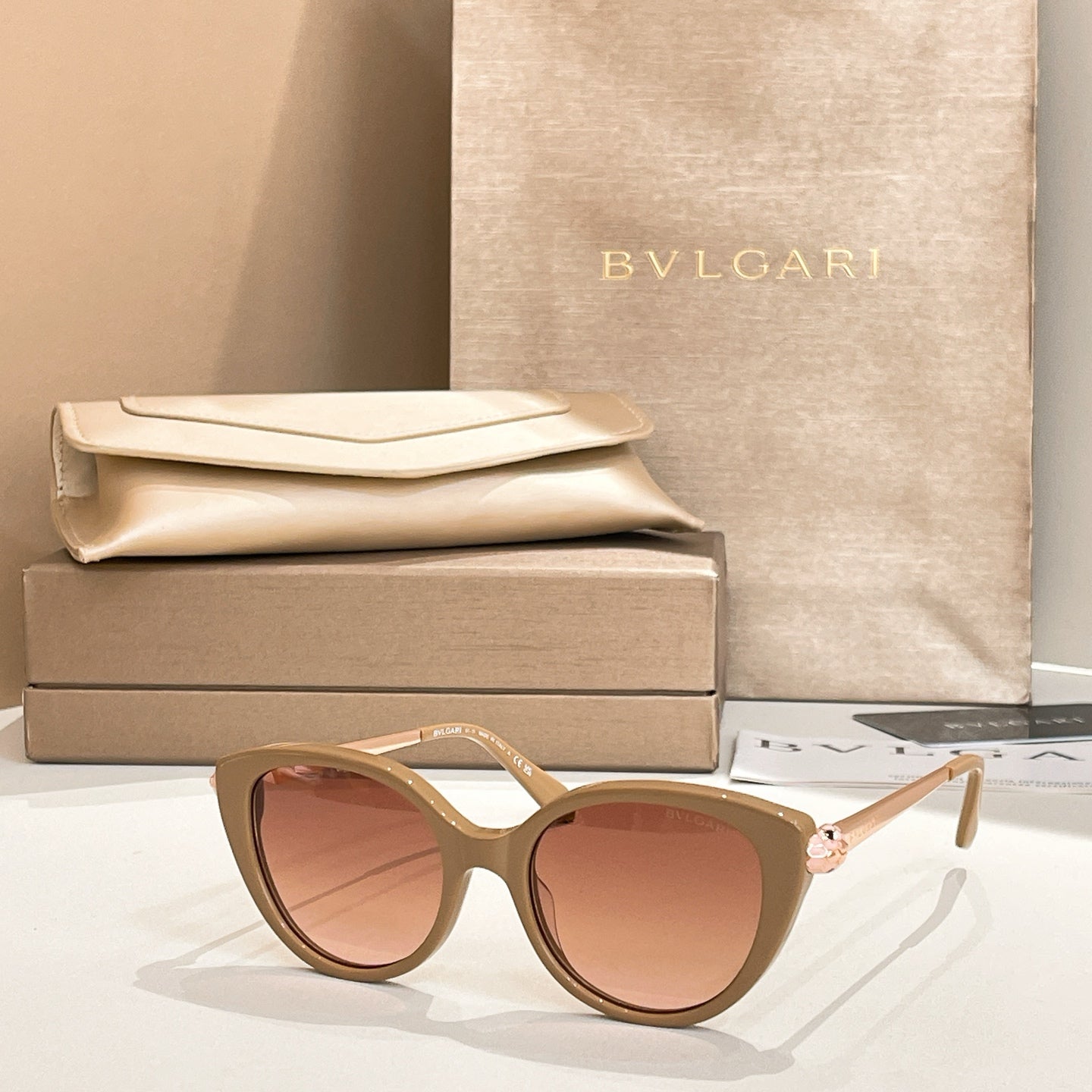 Gold-beige round sunglasses with gold-tone temple detail and brown-tinted lenses