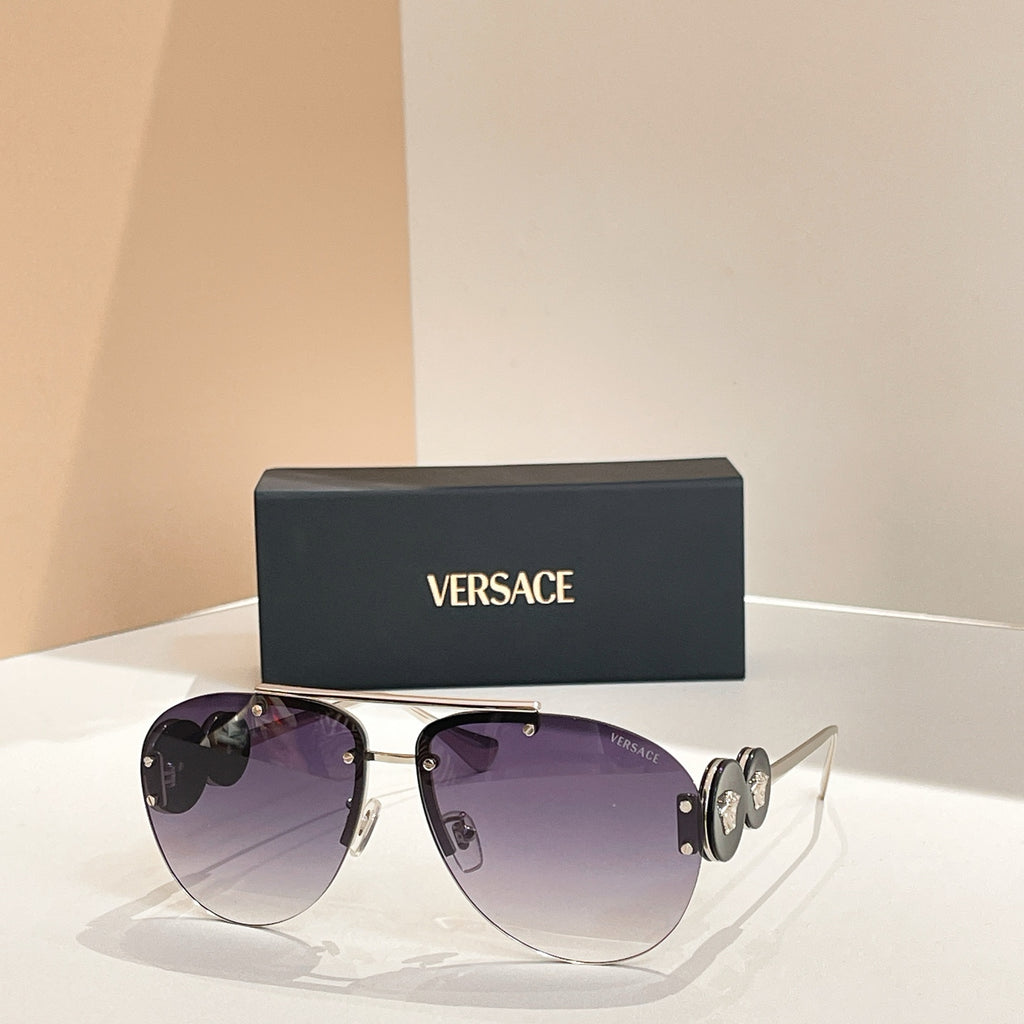 Versace sunglasses with gold frame and dark purple lenses; logo detail on temple arms