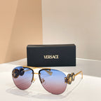 Versace sunglasses with gold frame and tinted purple-brown lenses; logo detail on temples