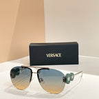Versace sunglasses with gold frame and blue gradient lenses; green logo on temple