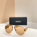Versace sunglasses with gold frame and warm tinted lenses; logo detail on temple arms