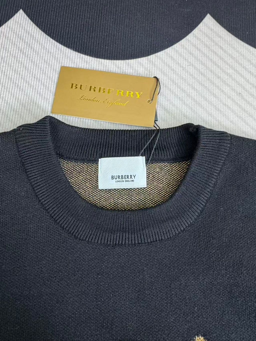 Navy sweater with ribbed crew neck and Burberry logo label at neckline
