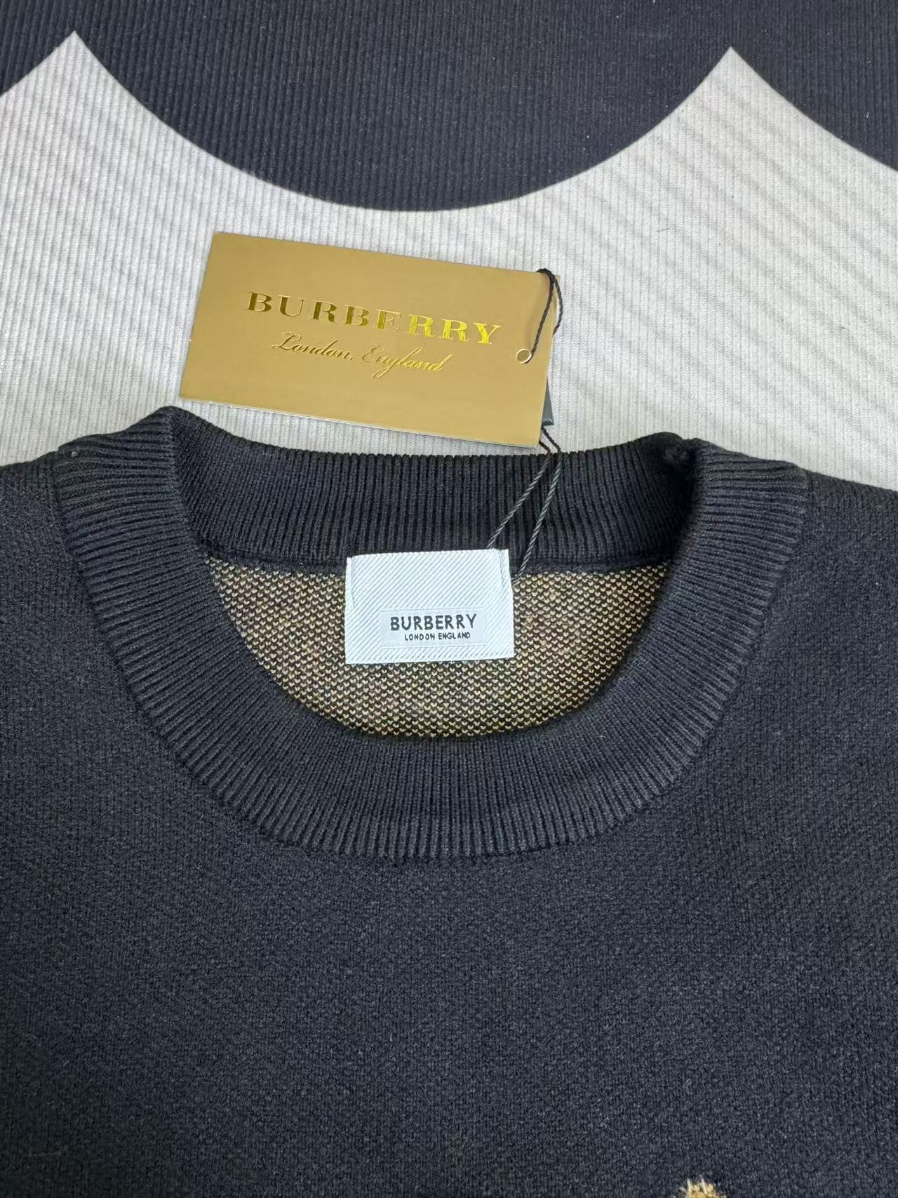 Navy sweater with ribbed crew neck and Burberry logo label at neckline