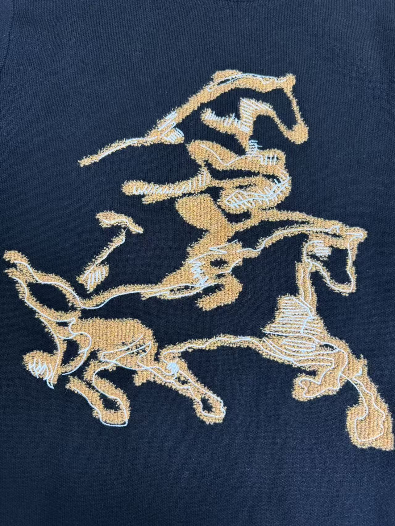 Navy sweater front featuring gold horse crest embroidered graphic