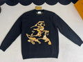 Navy long-sleeve sweater with gold horse crest graphic on the front