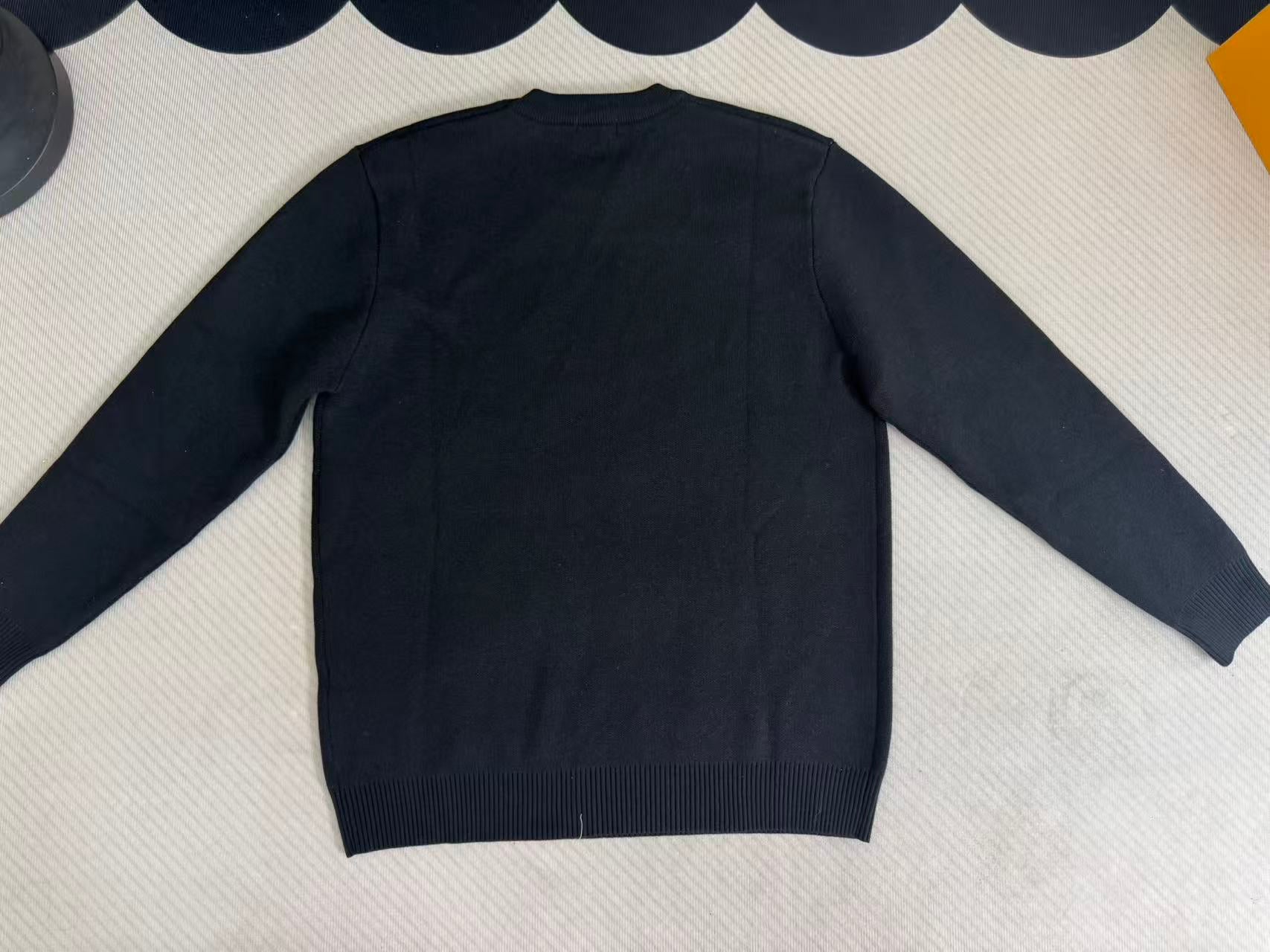 Navy long-sleeve sweater back view with ribbed hem and cuffs