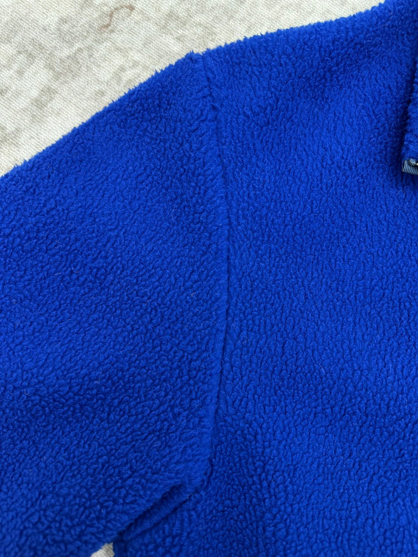 Givenchy blue fleece jacket side seam and zipper edge