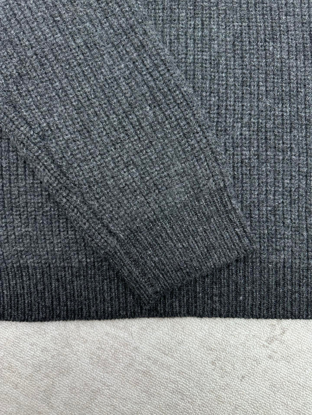 Gucci dark charcoal knit fabric texture on sleeve