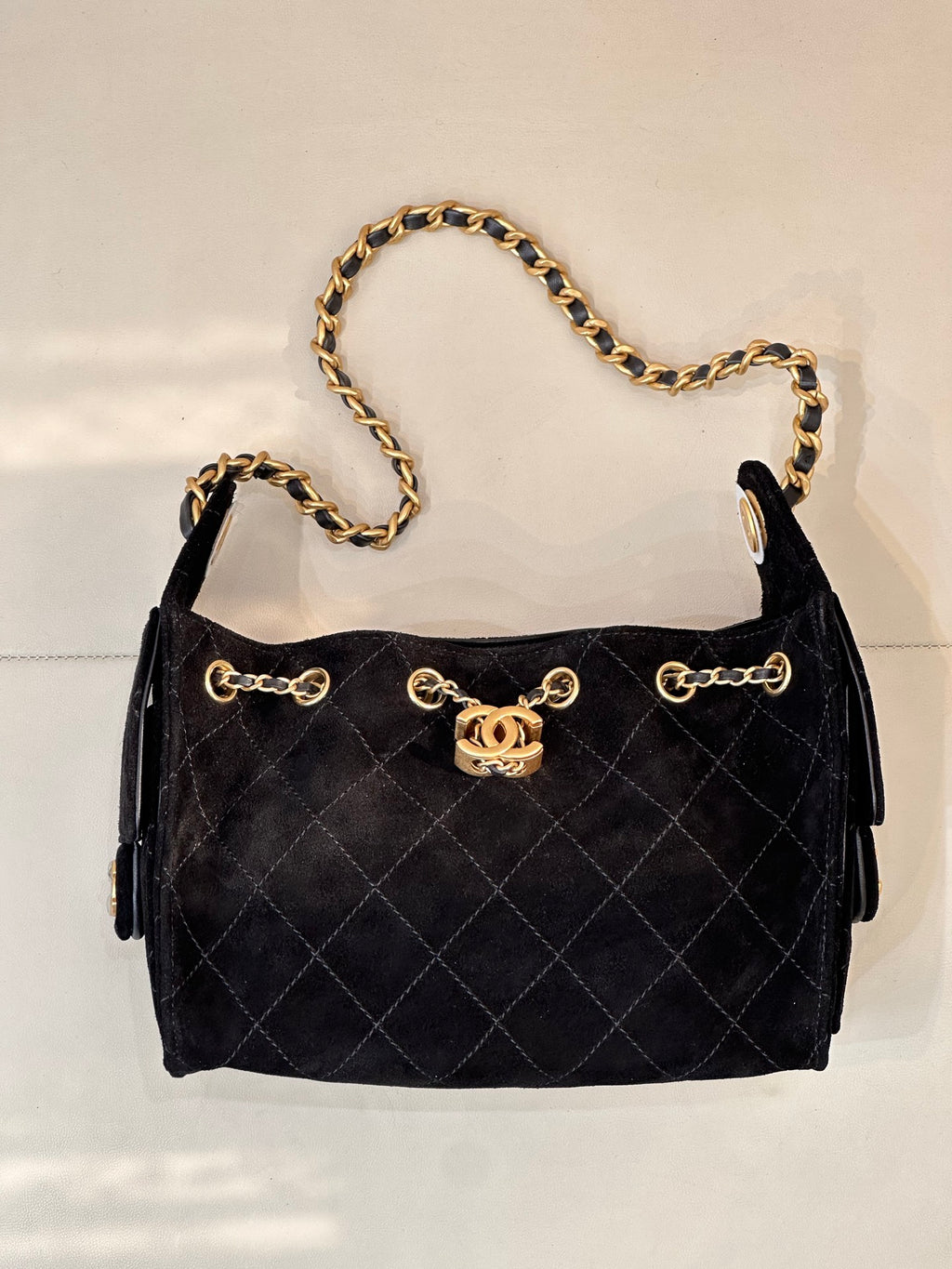 Chanel quilted handbag with gold chain shoulder strap and side pull tabs, black