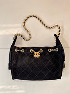 Chanel quilted handbag with gold chain shoulder strap and side pull tabs, black