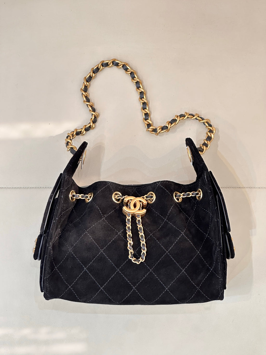 Chanel quilted handbag with gold chain strap and front flap, black fabric