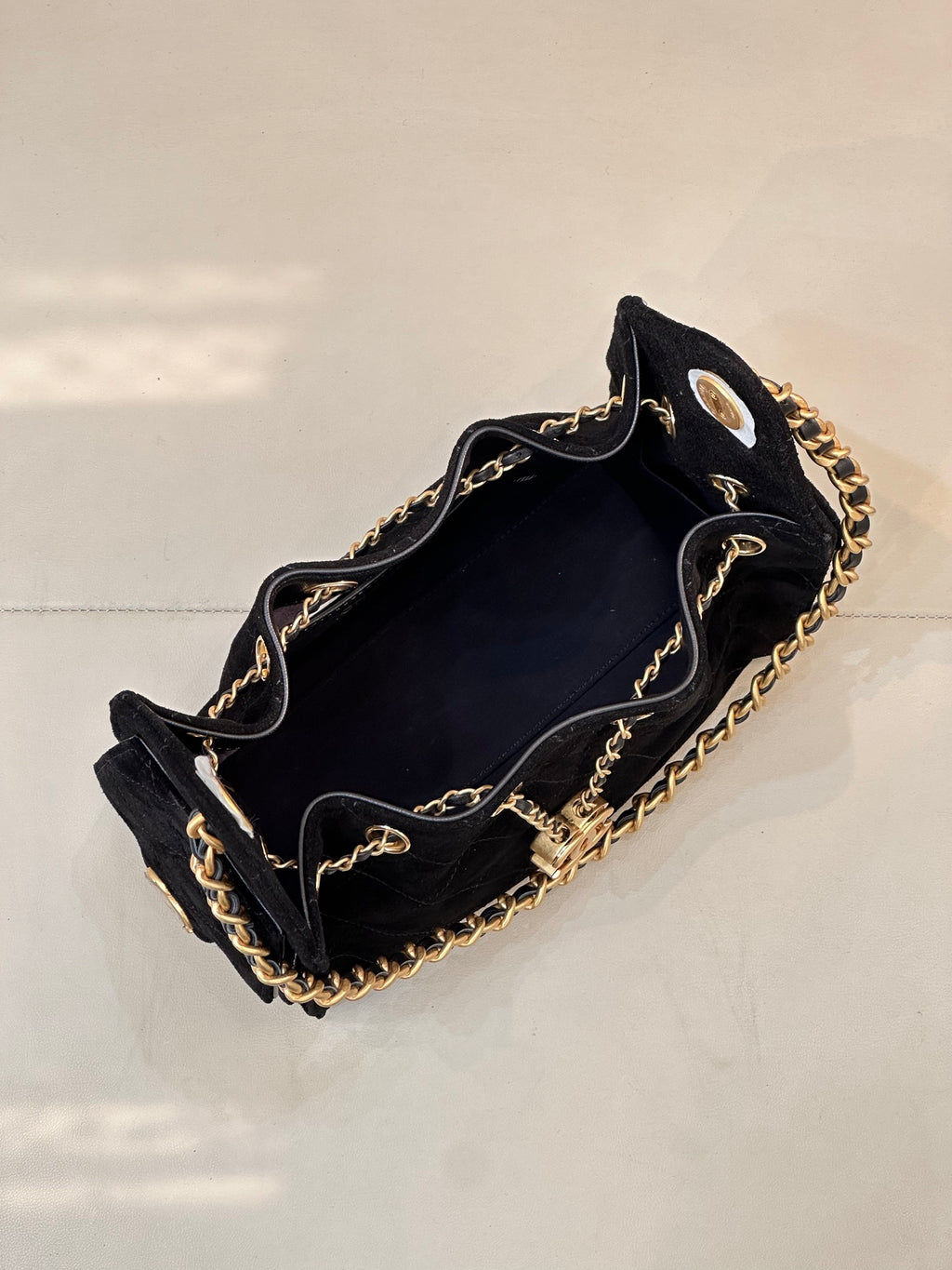 Chanel quilted handbag open-top view with gold chain trim, black