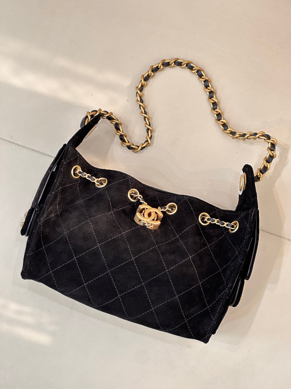 Chanel quilted handbag with gold chain strap and front logo emblem, black