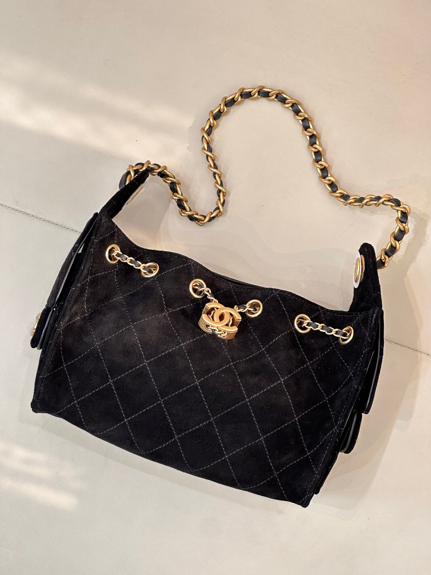 Chanel quilted handbag with gold chain strap and front logo emblem, black