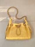 Chanel yellow quilted bucket handbag with chain handle and drawstring tassels
