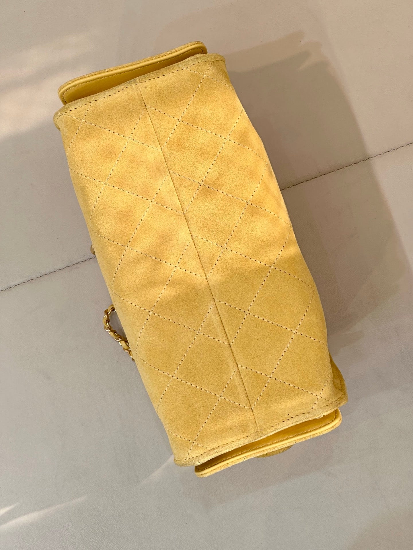 Chanel yellow quilted flap phone holder with chain strap, side view