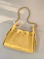 Chanel yellow quilted bucket handbag with gold chain strap and side tassels