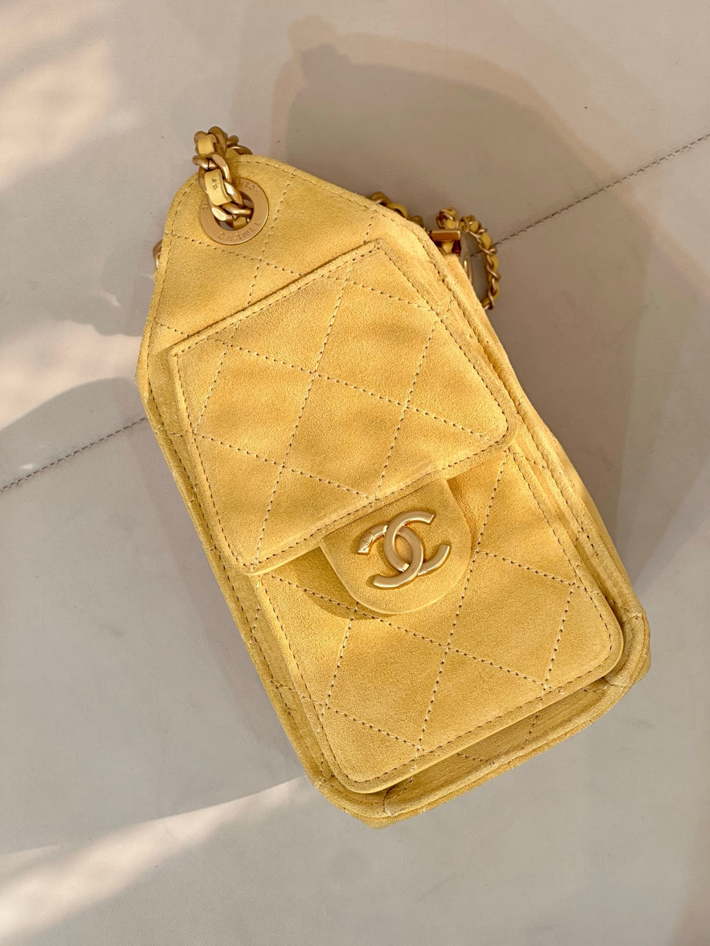 Chanel yellow quilted flap phone holder with CC logo and chain strap