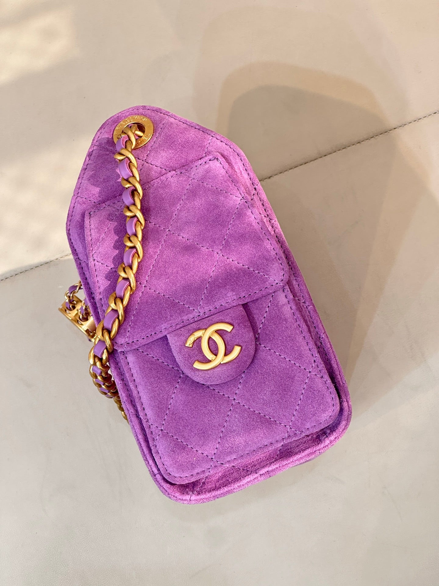 Purple Chanel mini handbag with flap, gold CC logo, and braided chain strap