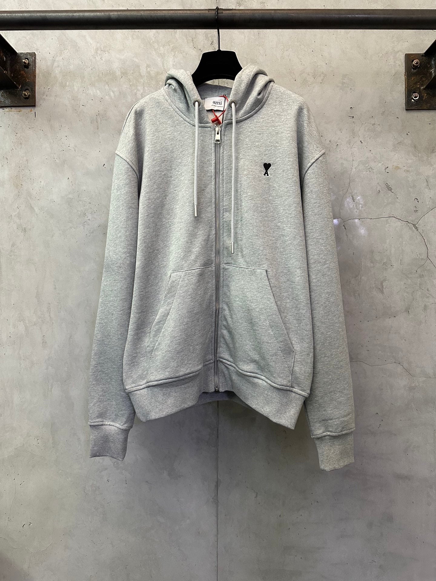 Light gray zip-up hoodie with hood, drawstrings, and front kangaroo pocket