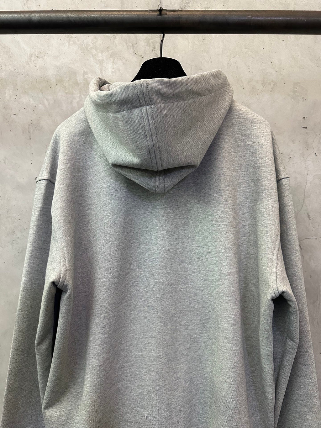 Light gray zip-up hoodie back view with hood and seam detailing