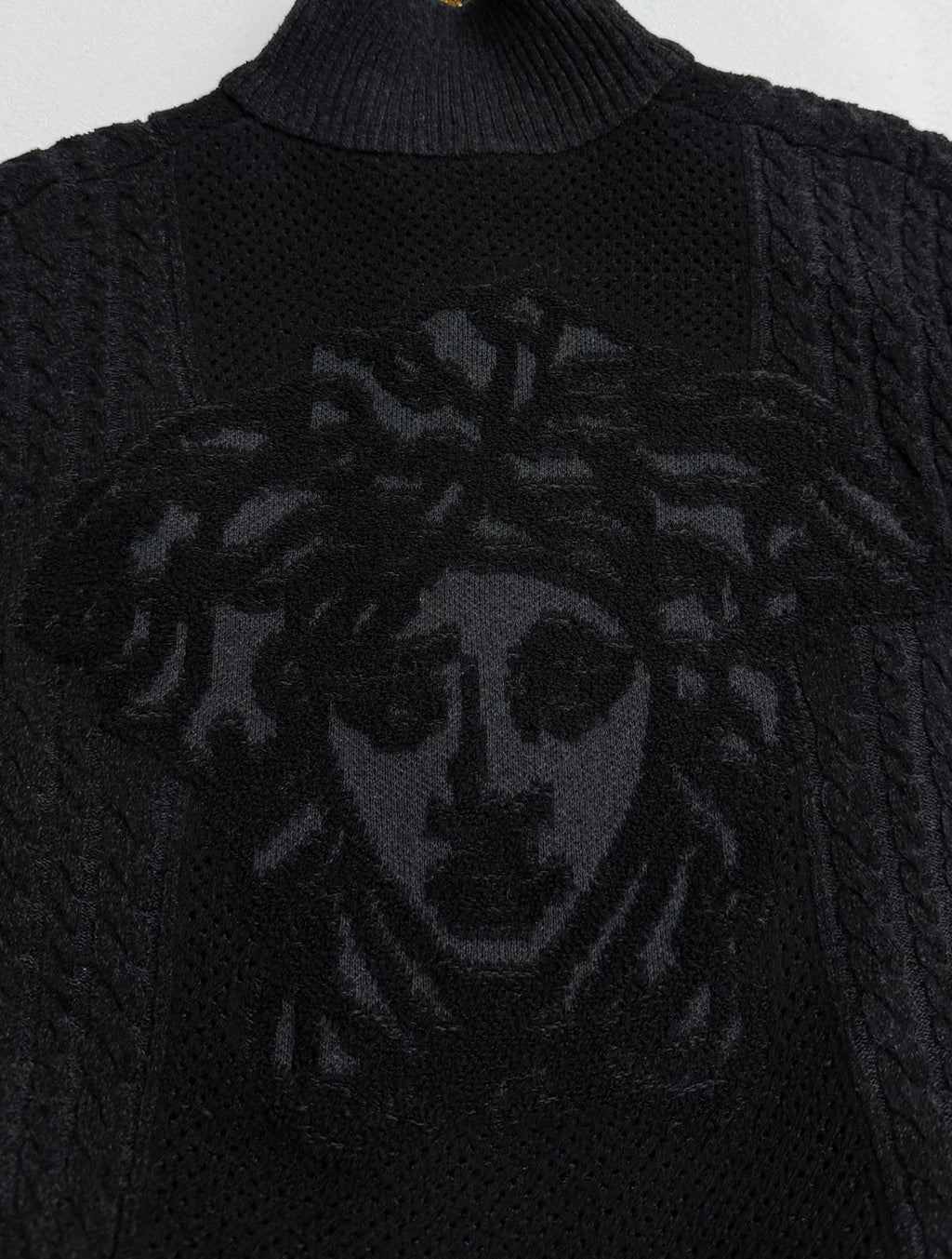 Versace black knit zip jacket with large lion-style graphic on chest